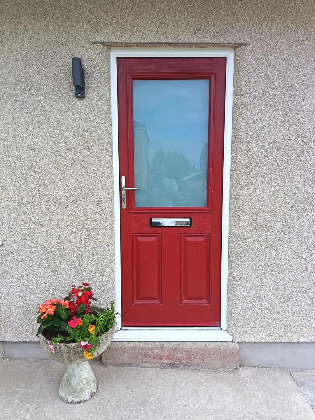 Welcoming red front door with flowers